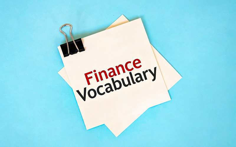 A white notepad with the words Finance Vocabulary